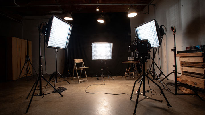 Simple and affordable video production setup with lights, camera, and minimal crew.